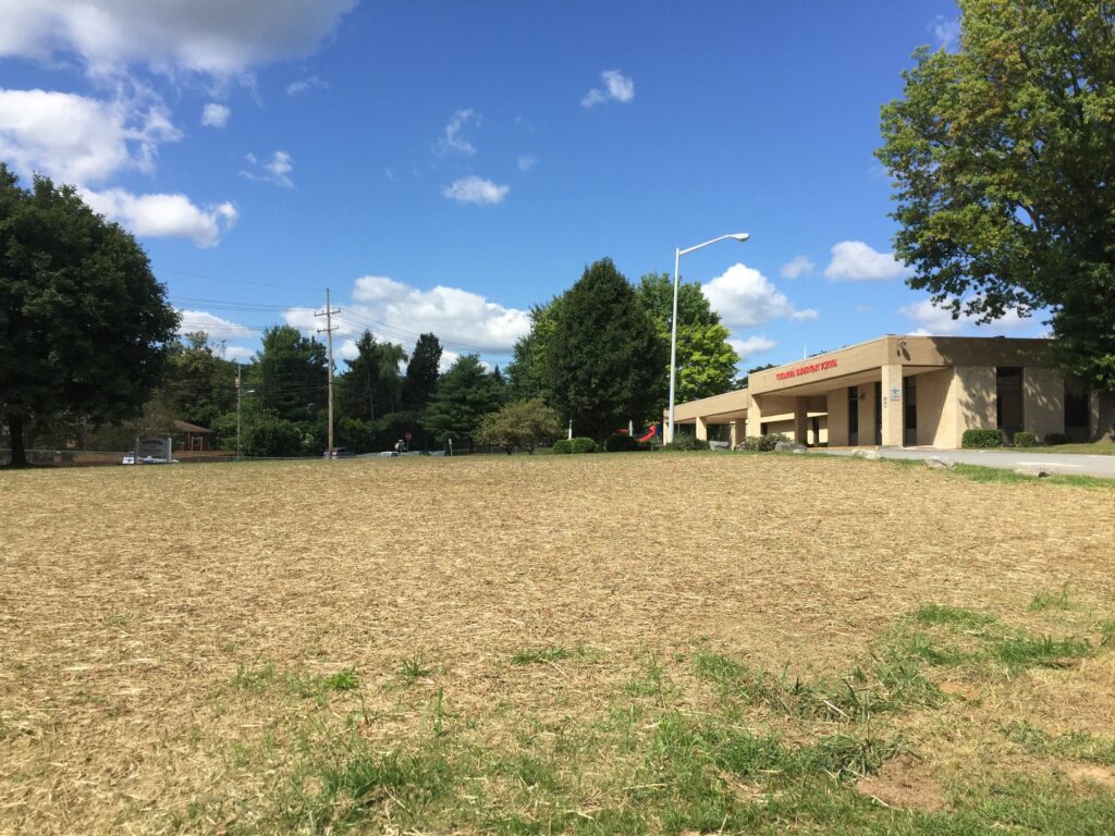 The front lawn of Tuscarora Elementary School in Berkeley County. Straw covers the ground to help grass grow back after 42 wells were built there in summer 2017 for the school's new geothermal heat pump system.