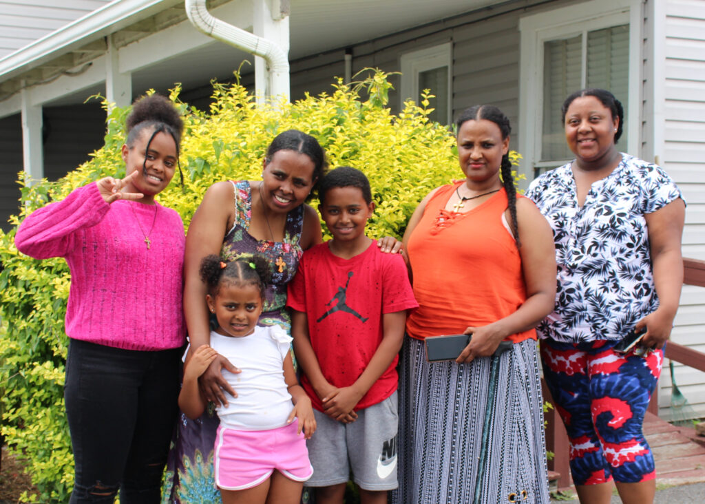 Trihas Kefele, a native of Eritrea, is one of the many immigrants who live in Moorefield, West Virginia. Pictured is Kefele, her children, and two coffee ceremony guests outside of her home.
