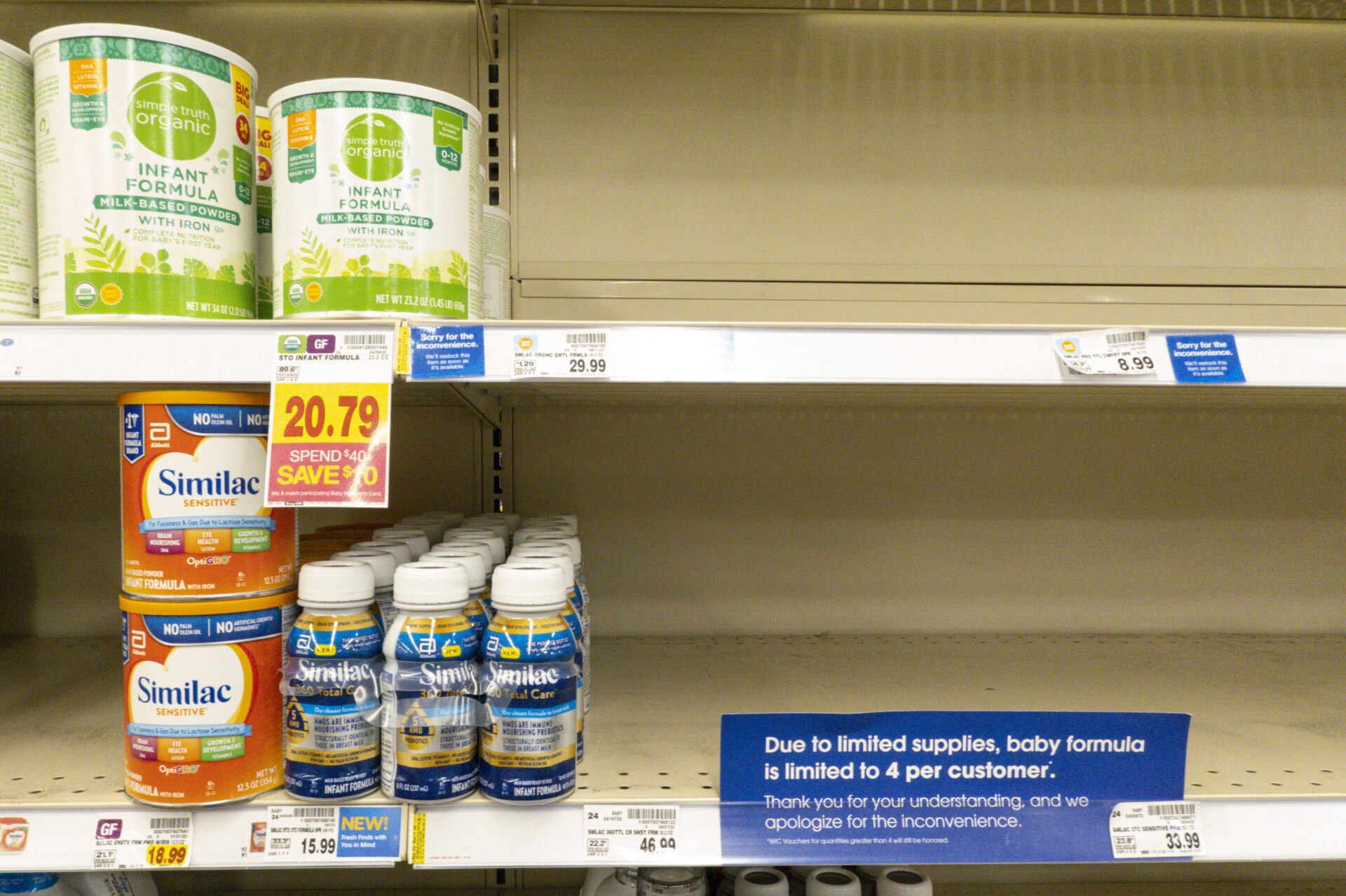 Baby formula is displayed on the shelves of a grocery store with a sign limiting purchases in Indianapolis.