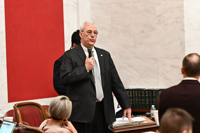 Sen. Charles Trump speaks into a microphone on the senate floor.