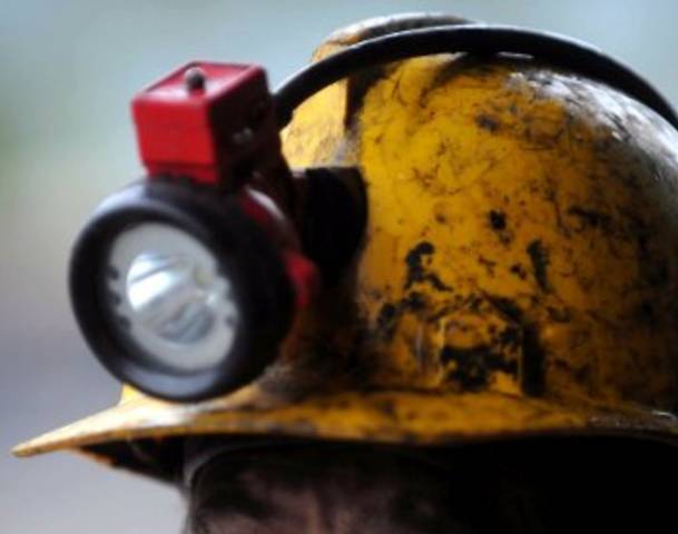 A close up on a coal miner's helmet.