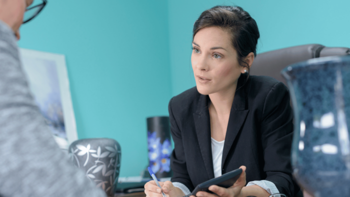 A funeral director discussing arrangements with a client.