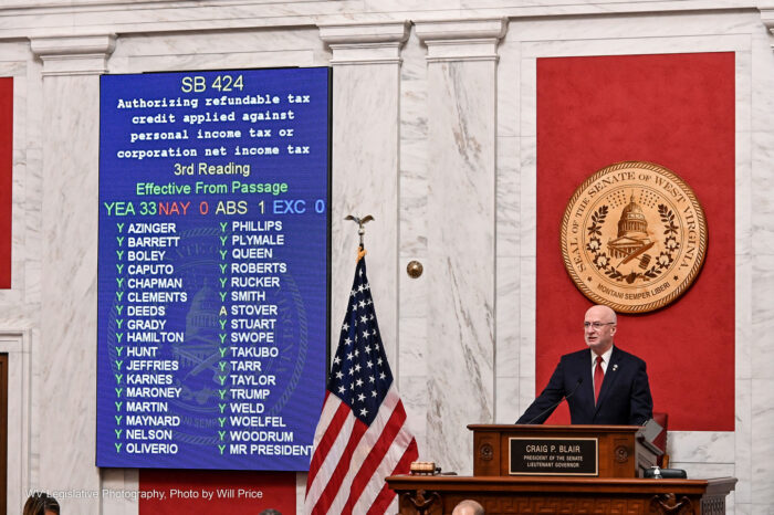 Sen. Craig Blair stands beside the voting wall.