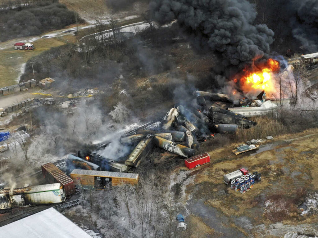 Rail cars burning after a train derailment near East Palestine Ohio.
