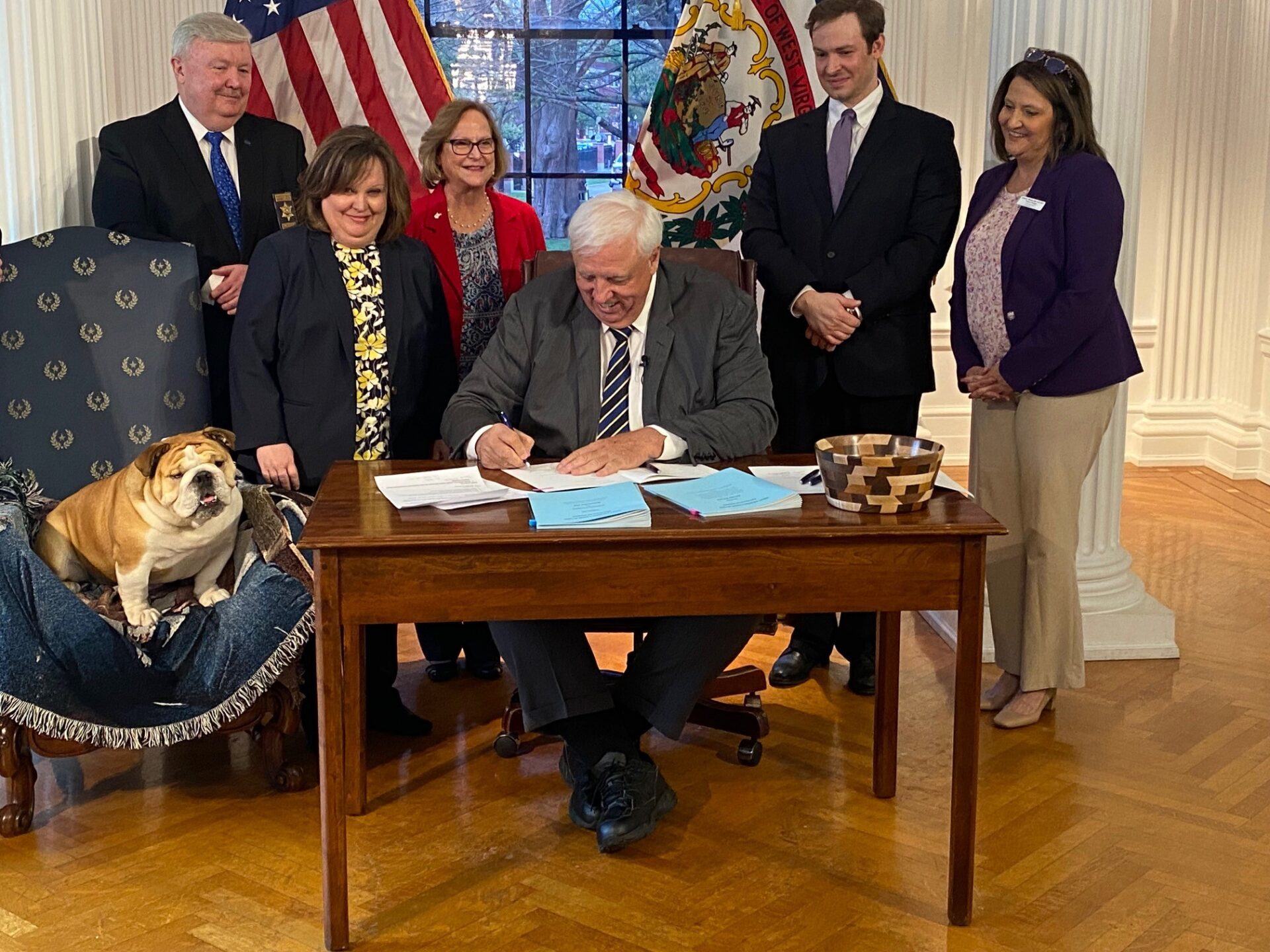 The Governor, with his English Bulldog Babydog at his side is in his grand reception room.