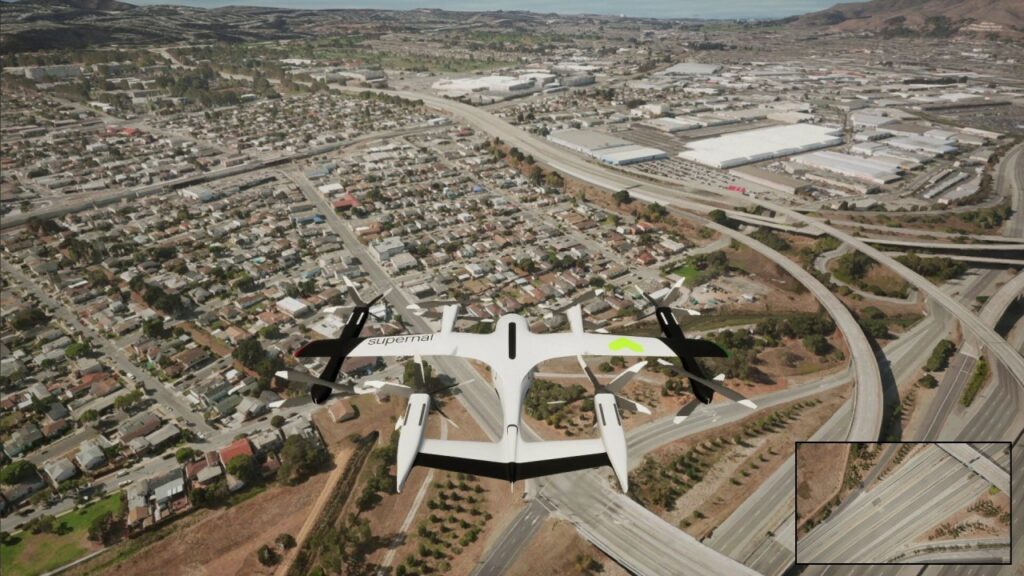 A drone, from its point of view, can be seen flying over a large city.