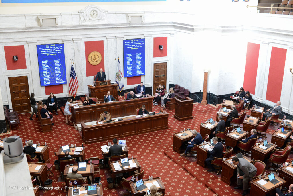 An overhead shot shows a wide view of the Senate floor. On the display is HB 2004, Prevent the use of payment card processing systems for surveillance of Second Amendment activity and discriminatory conduct.