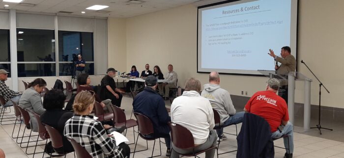 Participants in a public hearing sit and listen to officials with the West Virginia Department of Environmental Protection.