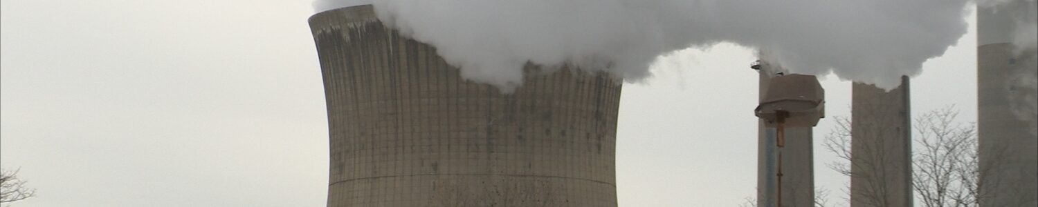 White steam billows from one of the concrete cooling towers at the Pleasants Power Station in Pleasants County.