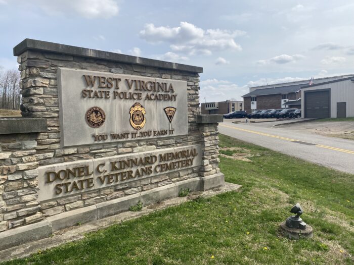 Large police sign with building in background