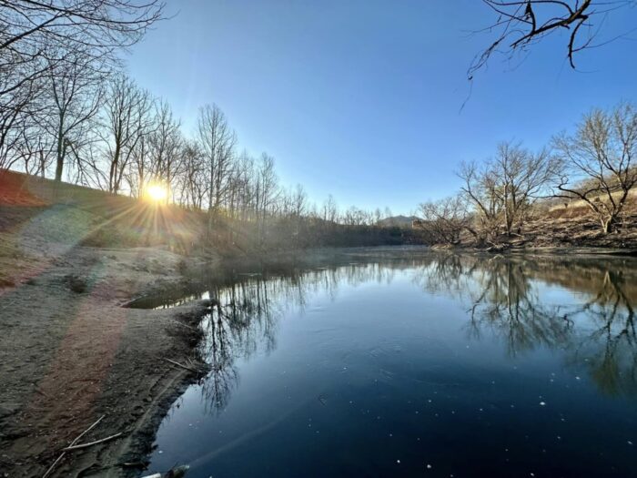 A scenic view of the Tug Fork River at sunrise.