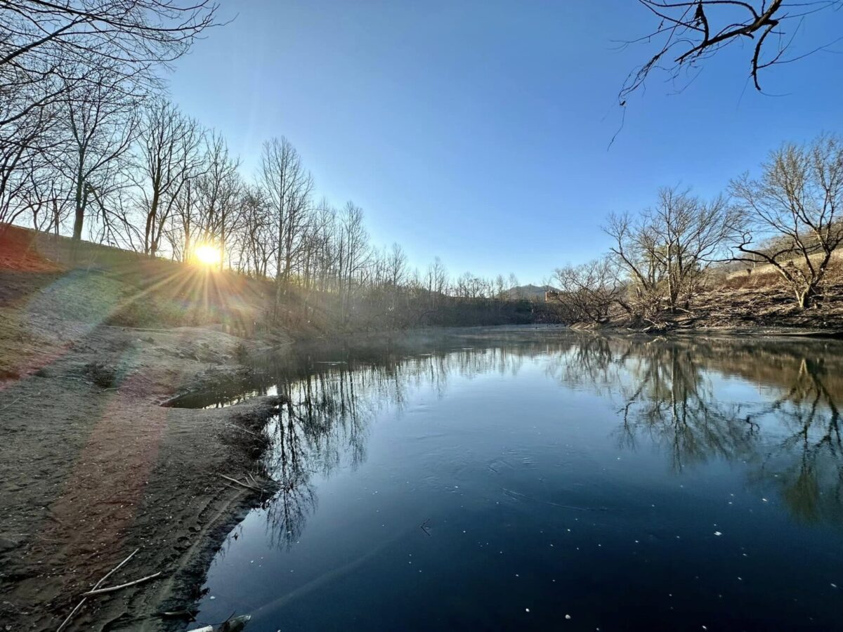 A scenic view of the Tug Fork River at sunrise.