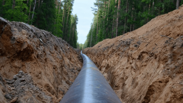 Natural gas pipeline construction work. A dug trench in the ground