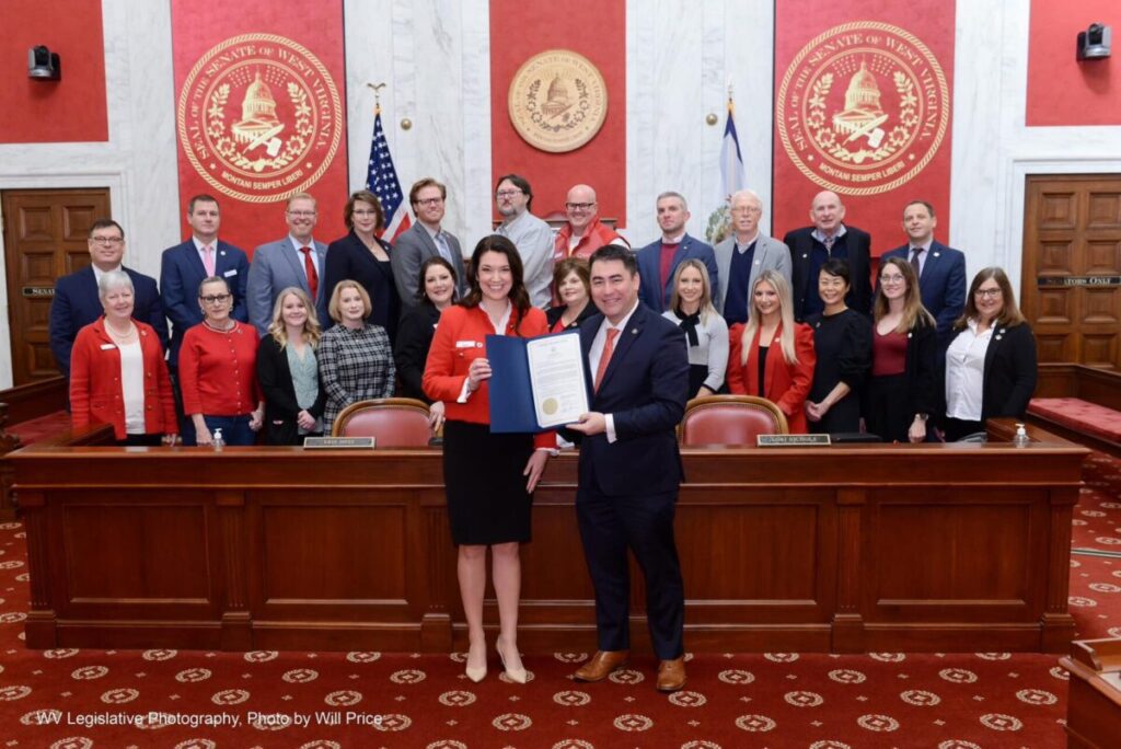 Members of the Central Appalachia Region of the American Red Cross standing inside the West Virginia Senate Chamber after being handed a copy of a Senate resolution declaring March as American Red Cross Month.