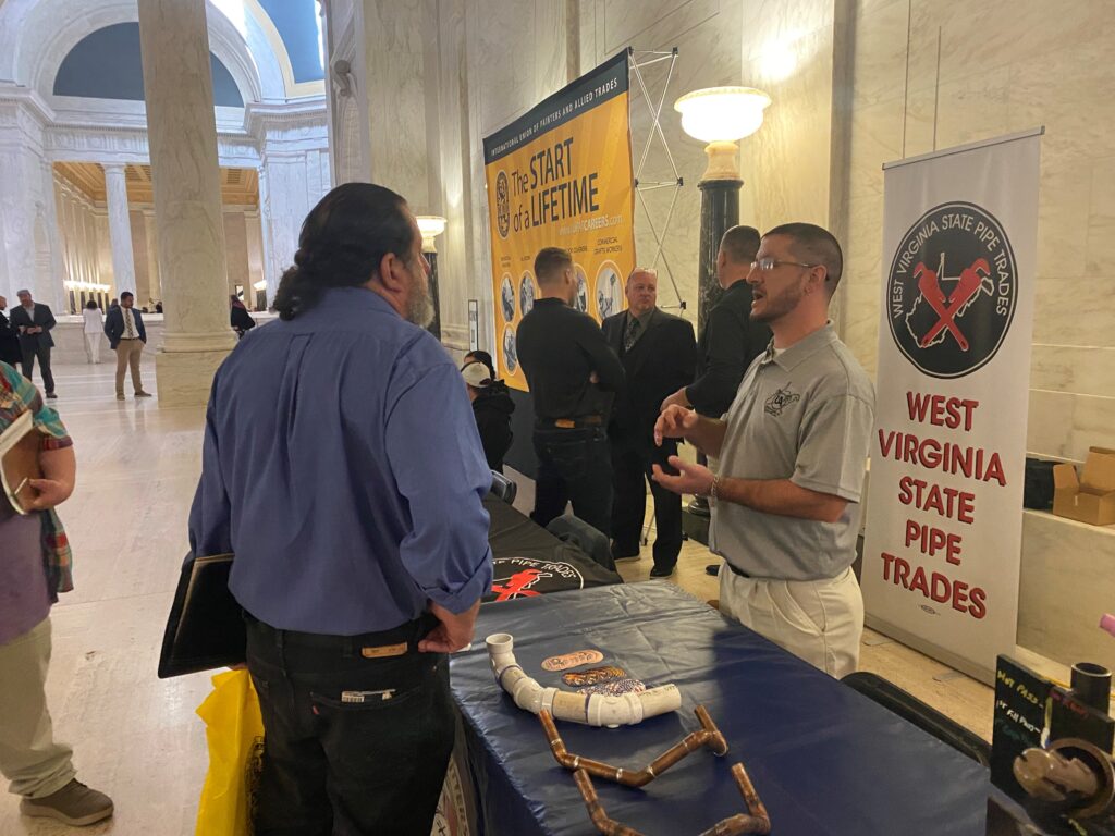Trades union representatives talk with the public at the Capitol.