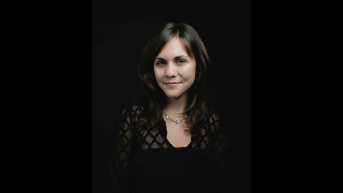 A photograph of a woman with long dark hair.