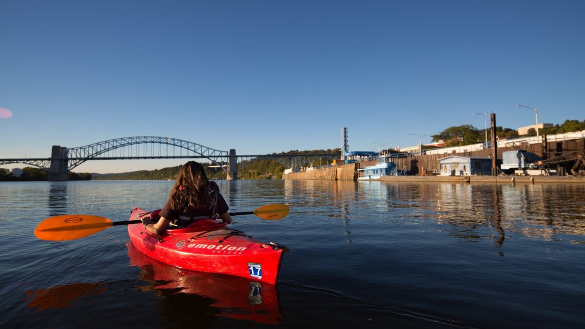 A picture of a person in a red kayak on the Ohio River. The nonprofit, national clean river environmental organization American Rivers has included the Ohio River on its annual list of America’s Most Endangered Rivers.