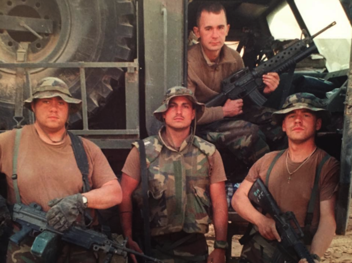 Four male soldiers dressed for combat in Iraq.