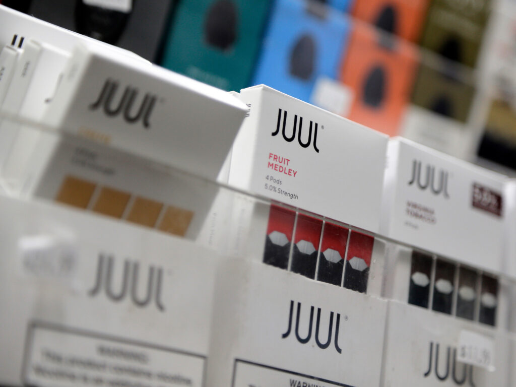 Three packets of Juul e-cigarettes are seen side-by-side.