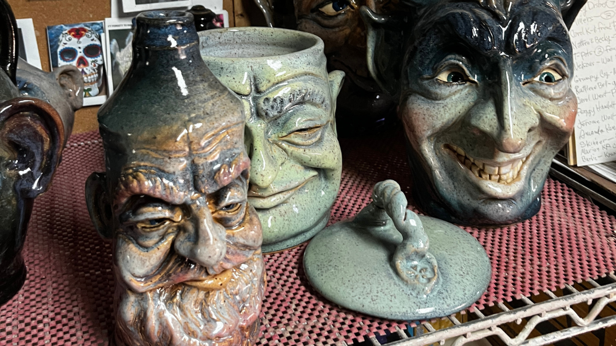 Three handmade face jugs.
