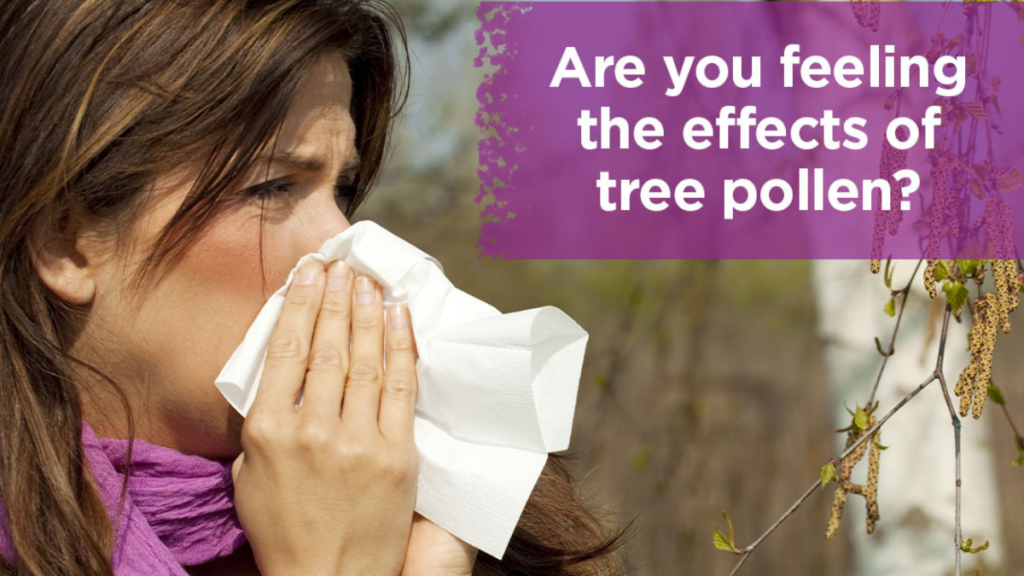 A picture of a woman sneezing into a tissue