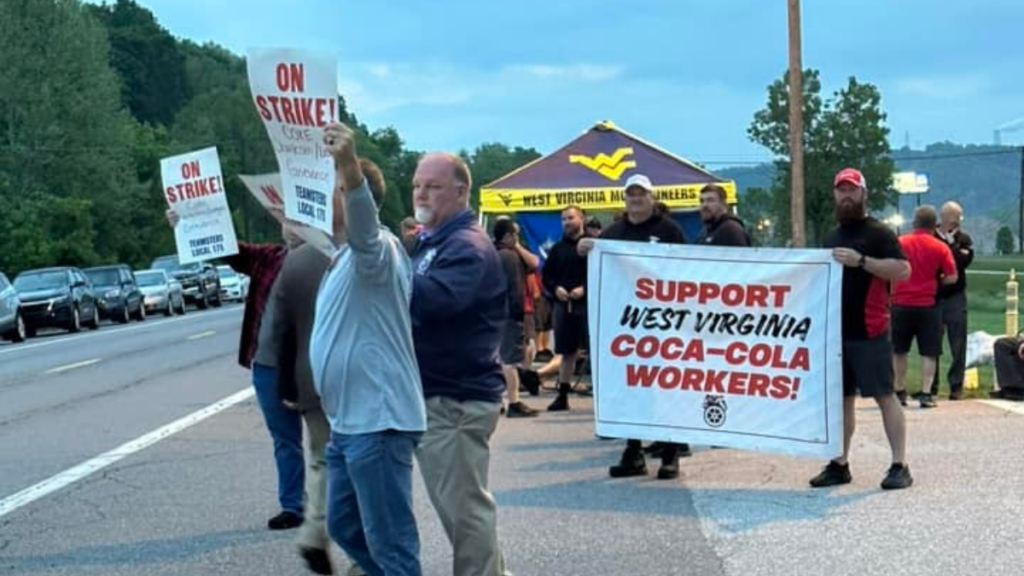A group of striking Coca-Cola workers standing on the side of a road in West Virginia.