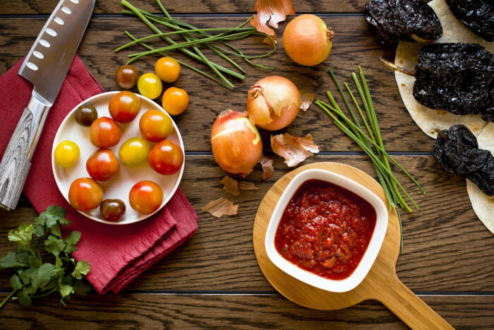 An assortment of fresh vegetables are laid out before being prepared for a meal.