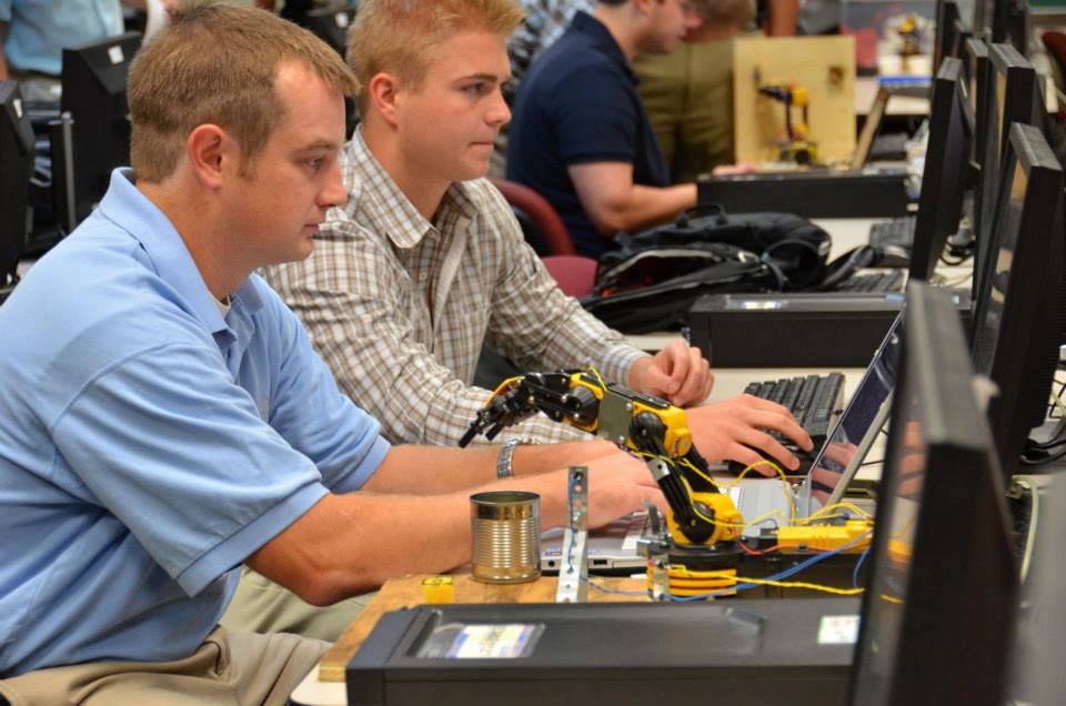 A picture of two young men looking at computers during an engineering class at West Virginia University.