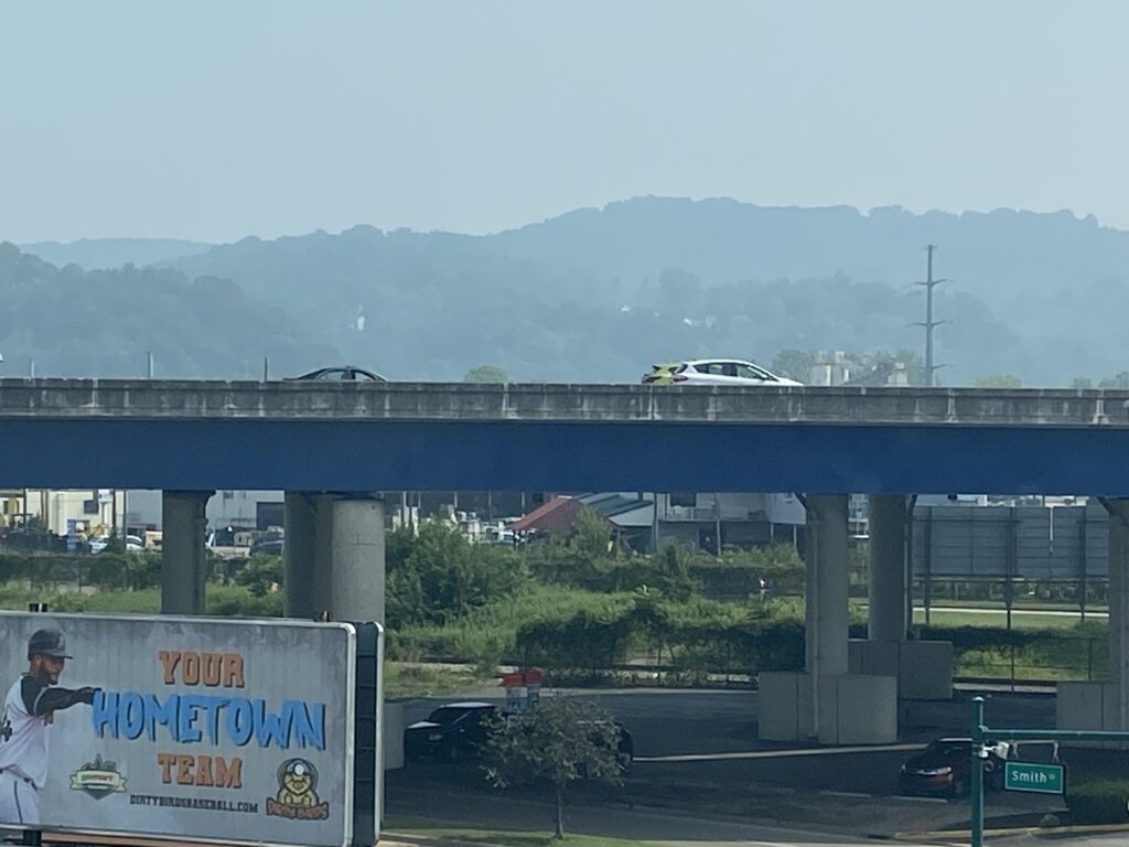 hills, highway and smoky skyline