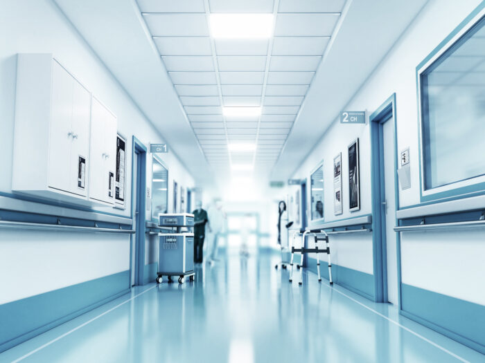 An empty hospital corridor or hallway. Medical concept. Hospital corridor with rooms. 3d illustration.