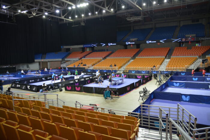 Nice tables sit in the middle of the convention center. There are six active matches taking place with players representing different countries.