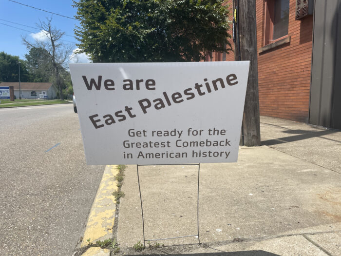 A white sign is shown. It reads, "We are East Palestine. Get ready for the greatest comeback in American history."