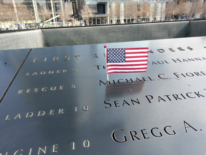 flag sticking ouf of names engraved in stone