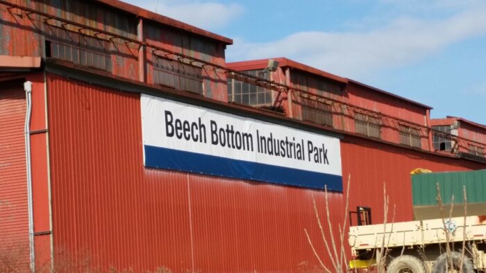 A red steel building with a blue and white sign