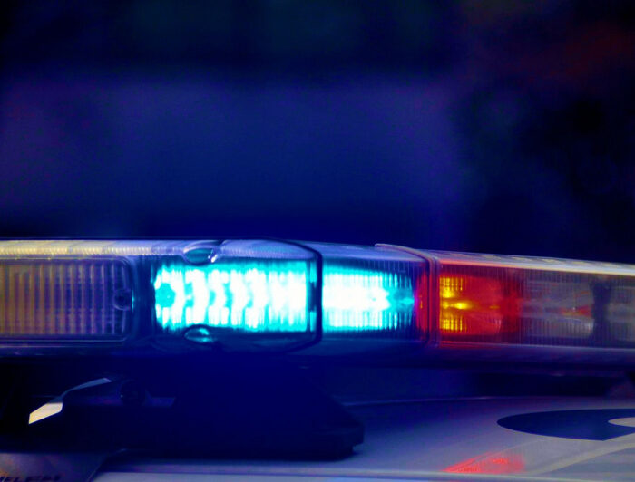 A picture of glue and red siren lights on top of a police cruiser