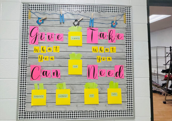 a board in that has says give what you can, take what you need.