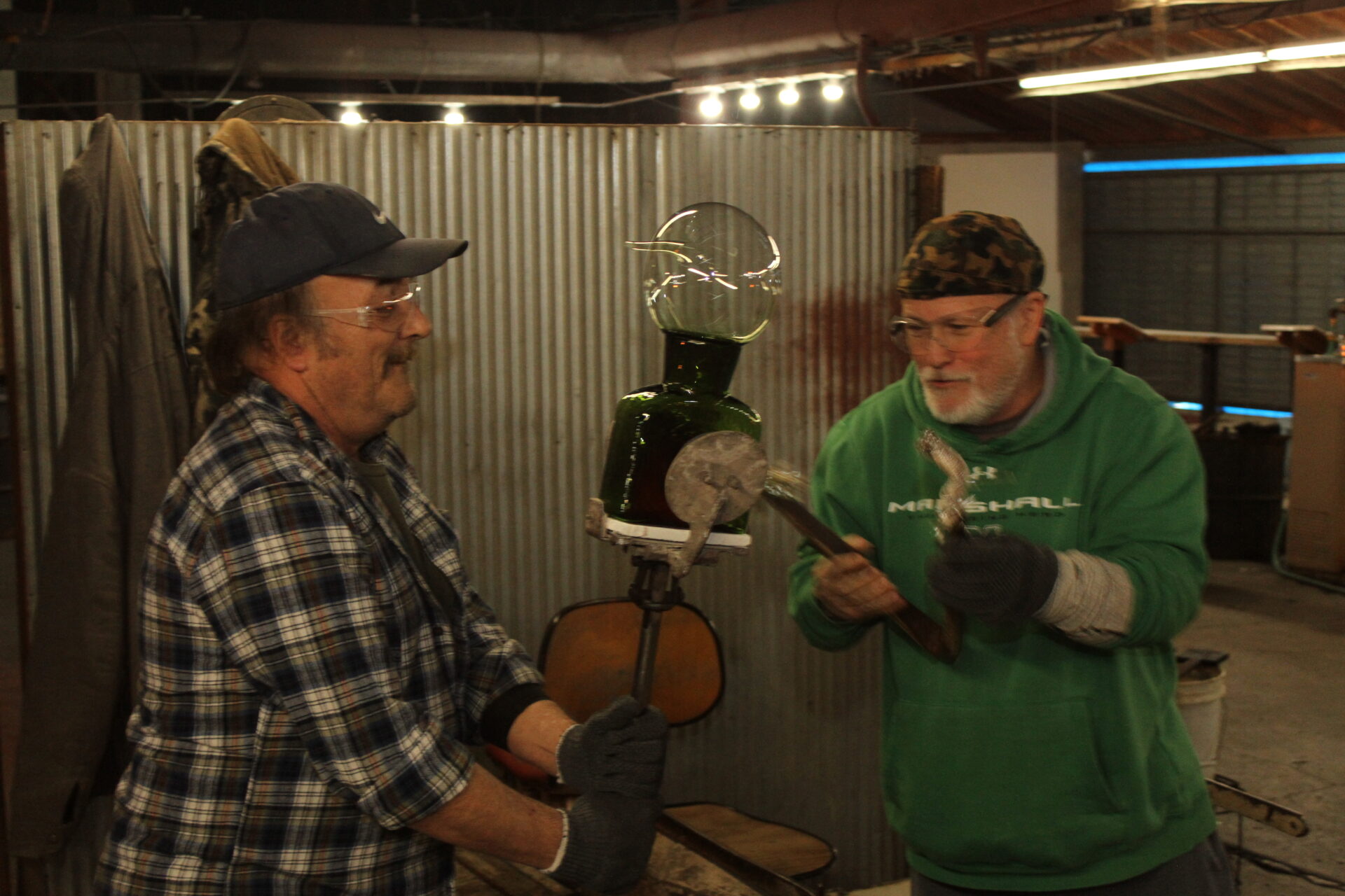 Two men working with handblown glass