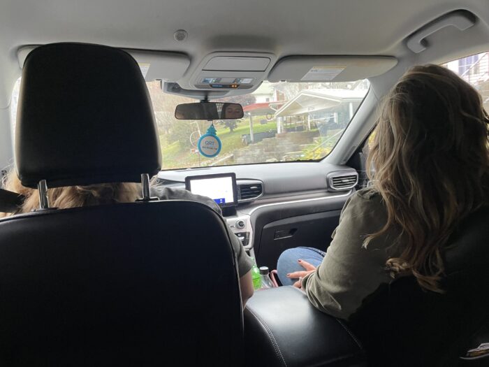 two women in a car, photo taken from the backseat.