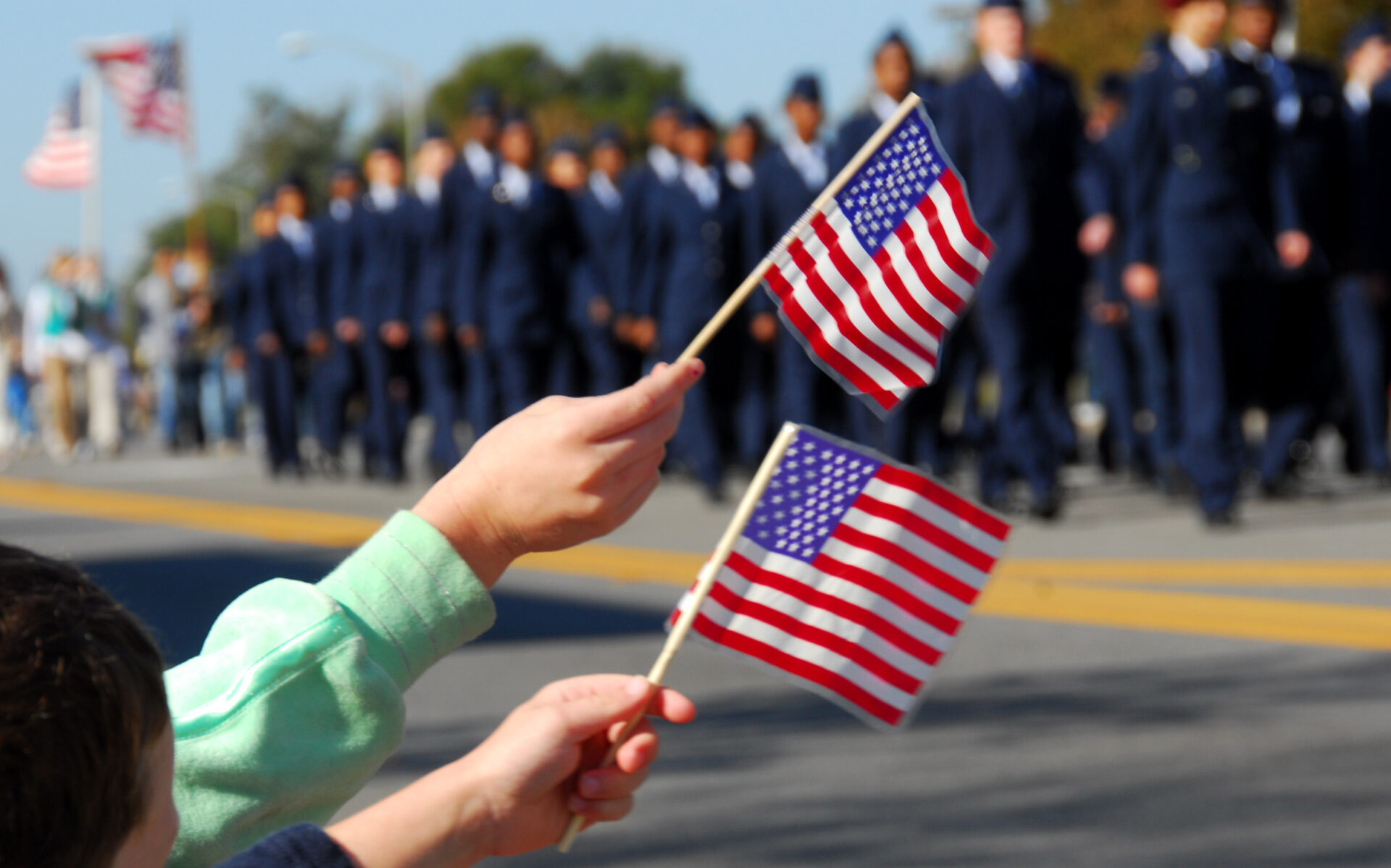 American flags are waved during a Veterans Day parade.