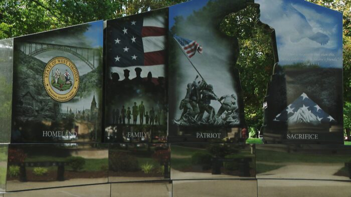 The Charleston, WV Gold Star Families Memorial Monument is show. One part of the monument reads Homeland, Family, Patriot, and Sacrifice.