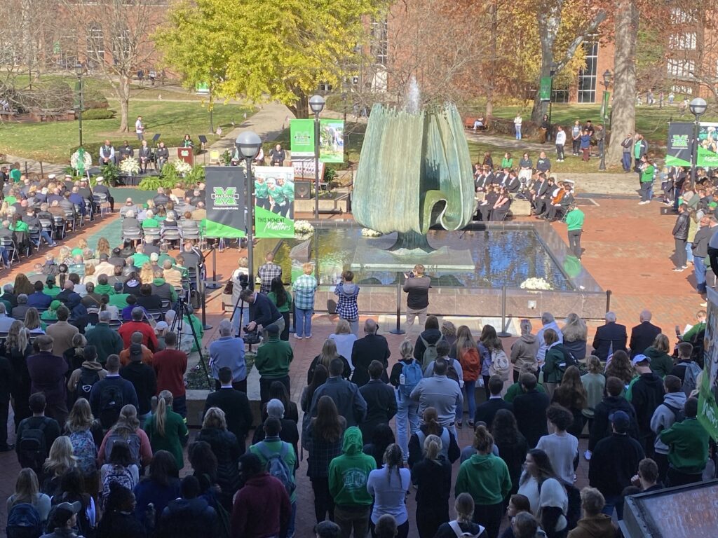 A few thousand people gathered around a university fountain.