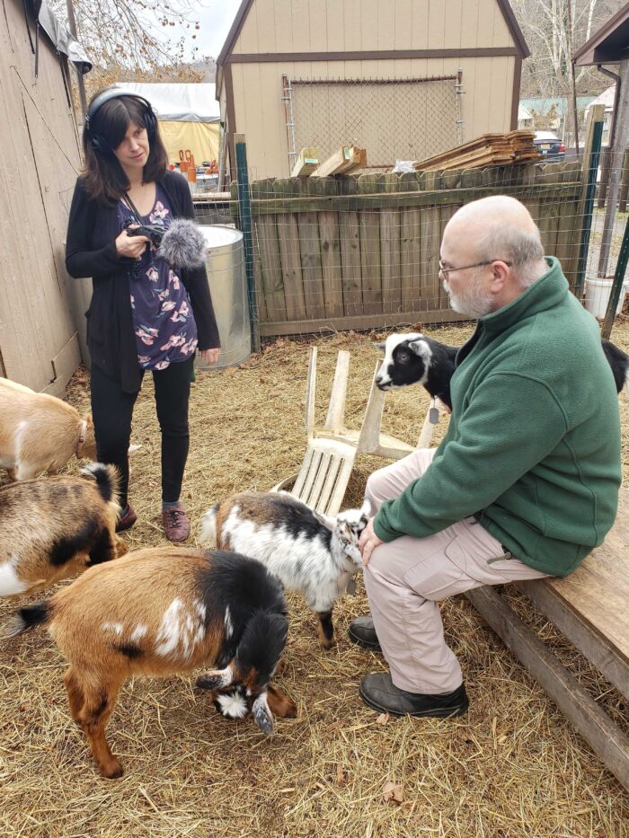 Roxy Todd stands with a few Nigerian Dwarf goats and talks with their owner Bob Keller, outside his survivalist shop in Cross Lanes, W.Va.