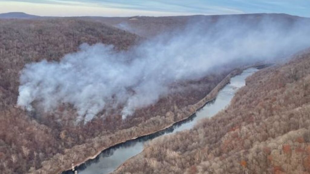 Smoke can be seen covering a large area of a mountainside