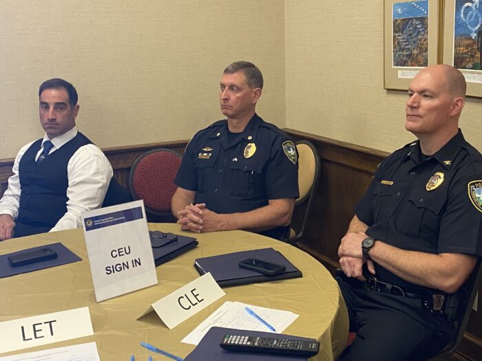 plain clothed FBI agent, two uniformed law enforcement officer at a table
