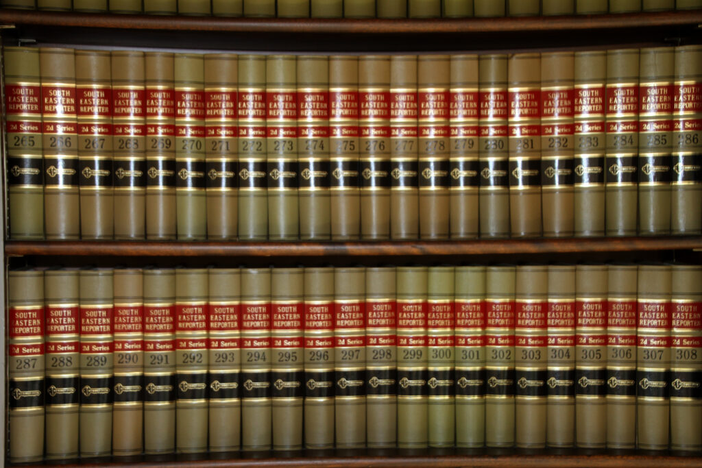 More than a dozen law books are shown on a bookshelf.