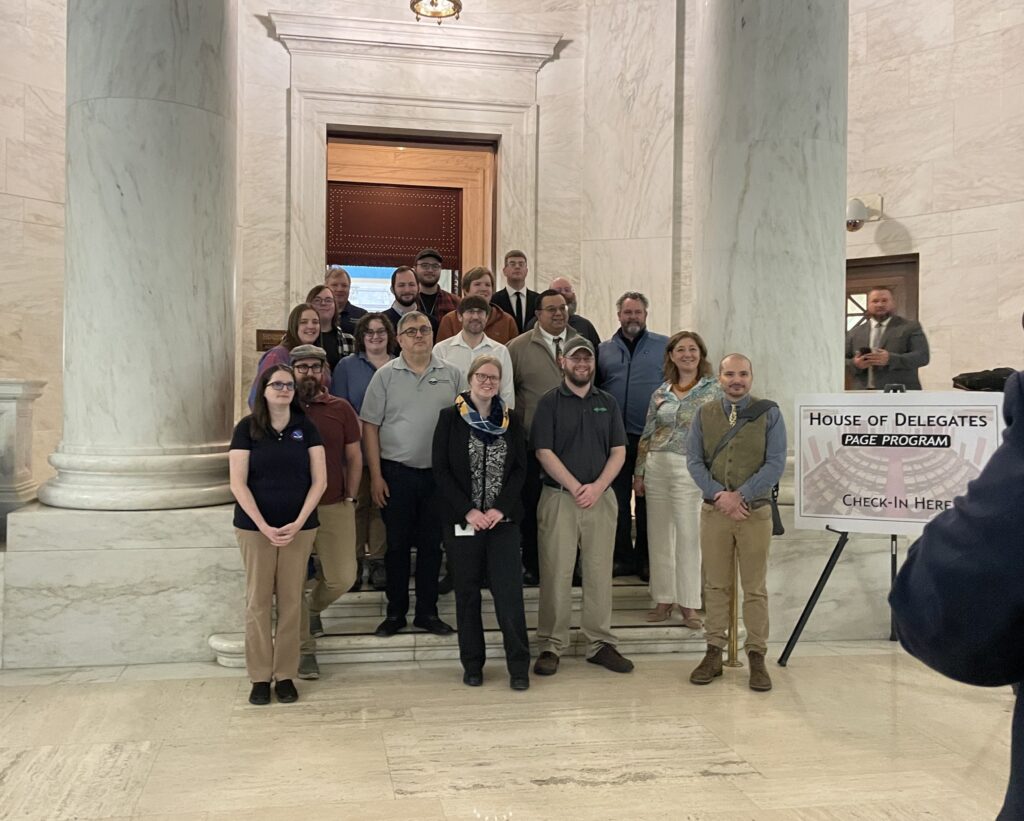 Geospatial professionals from across West Virginia stand on a staircase at the state capitol, posing for a group photo.