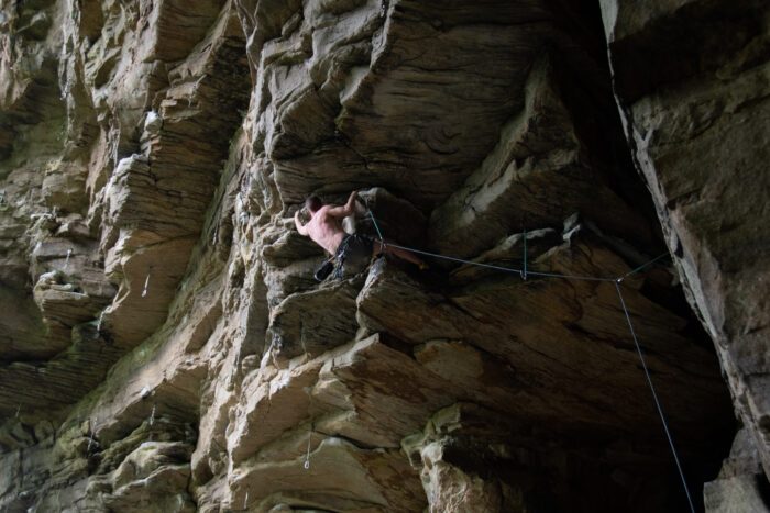 A climber scales a rock face.