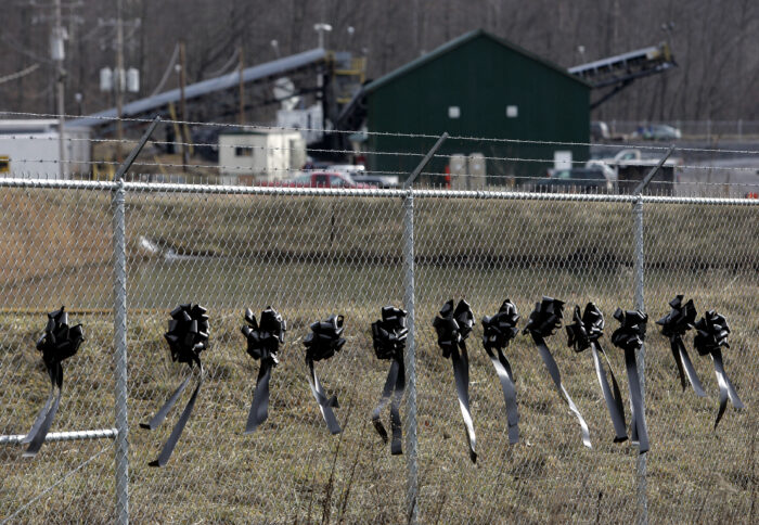 Black ribbons tied to a chain link fence