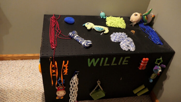 A child's toybox with a black background and red letters.