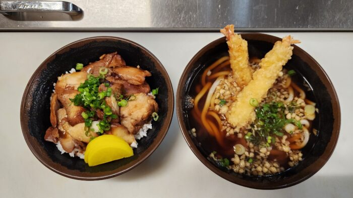 Two bowls of freshly made Japanese food are shown side-by-side on a counter.